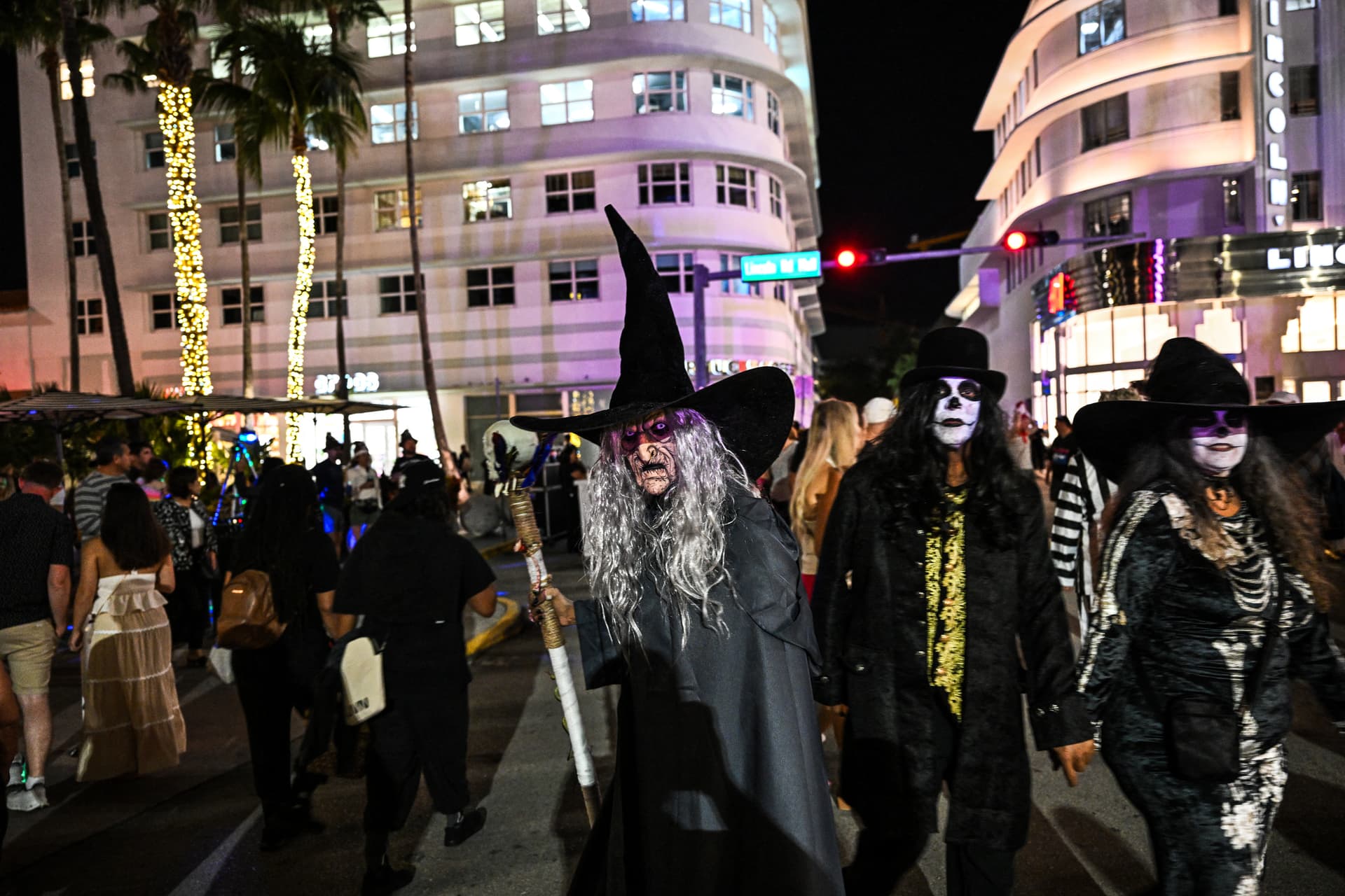 People in costumes take part in the Halloween street party in Miami